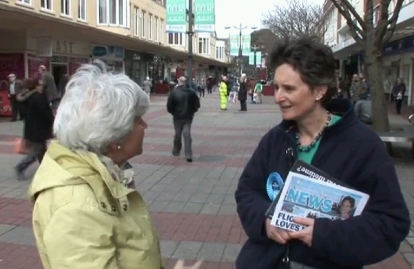 Flick talking to a voter at a street stall